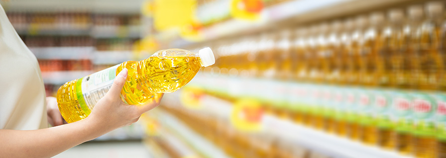 woman buying cooking oil at a supermarket