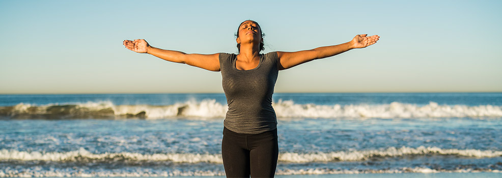 Mujer practicando fitness en la playa