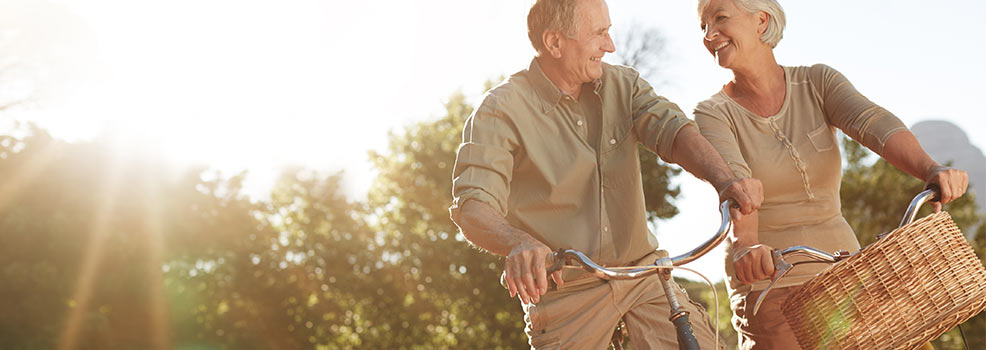 Old couple riding a bikes.