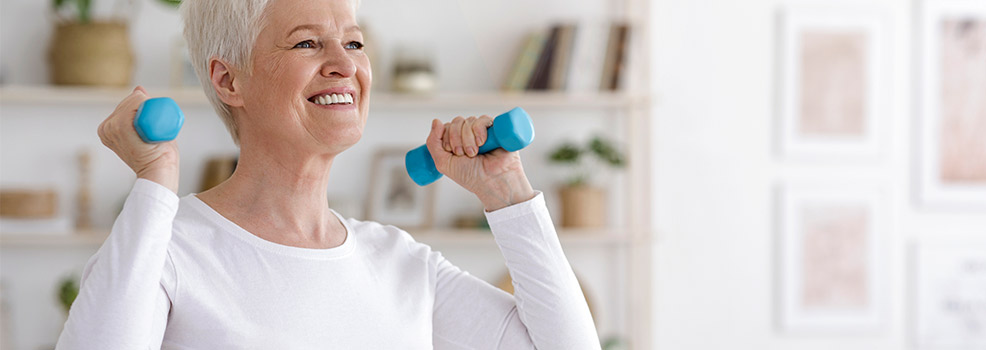 Old woman lifting dumbbells.