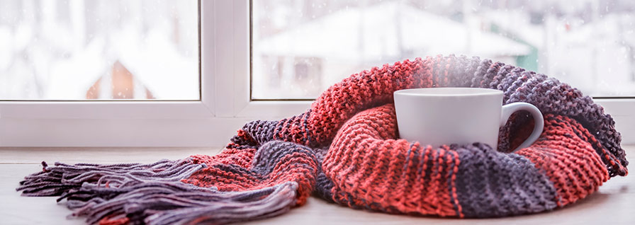 hot tea and knitted scarf