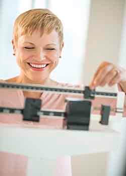 Woman measuring her weight