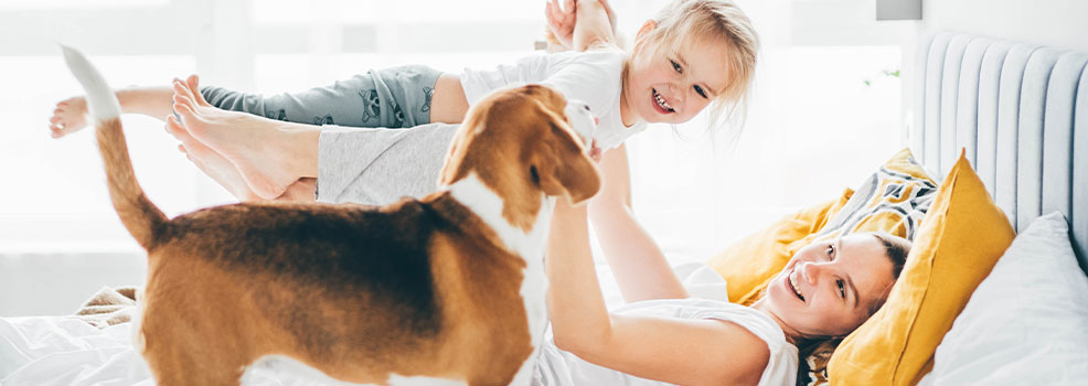 Happy mother and daughter with dog