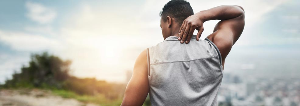 Man holding the back of his neck