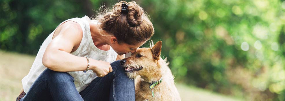 Woman sitting with her pet dog.