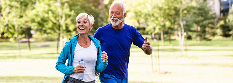 happy senior couple jogging