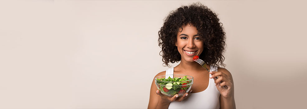Woman eating vegetable