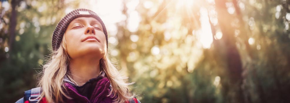 Woman feeling the sunlight on her face