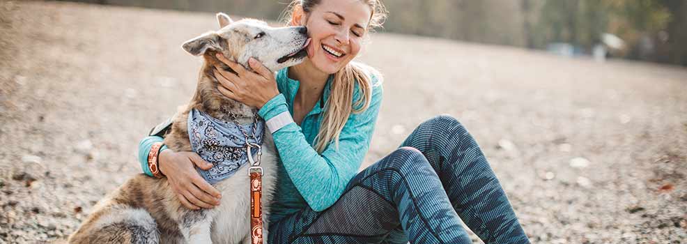 Young woman hugging her dog.
