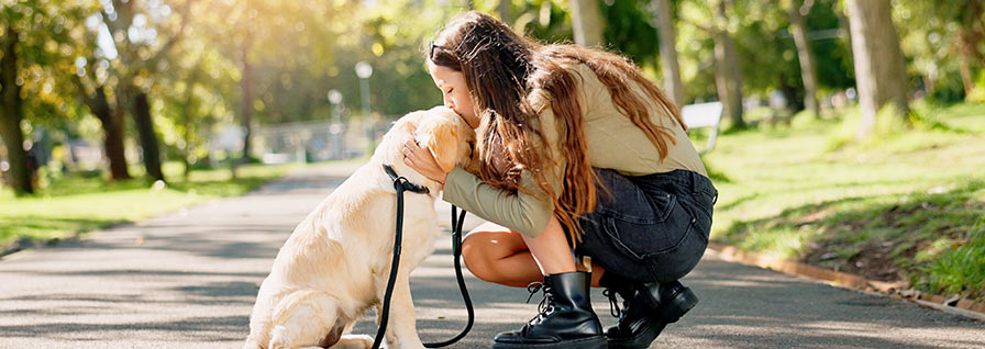 woman kissing pet dog