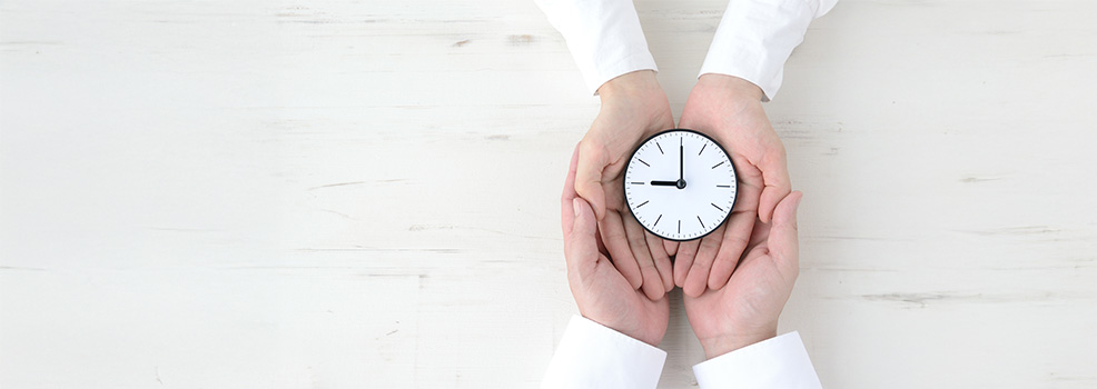 manos sosteniendo un reloj
